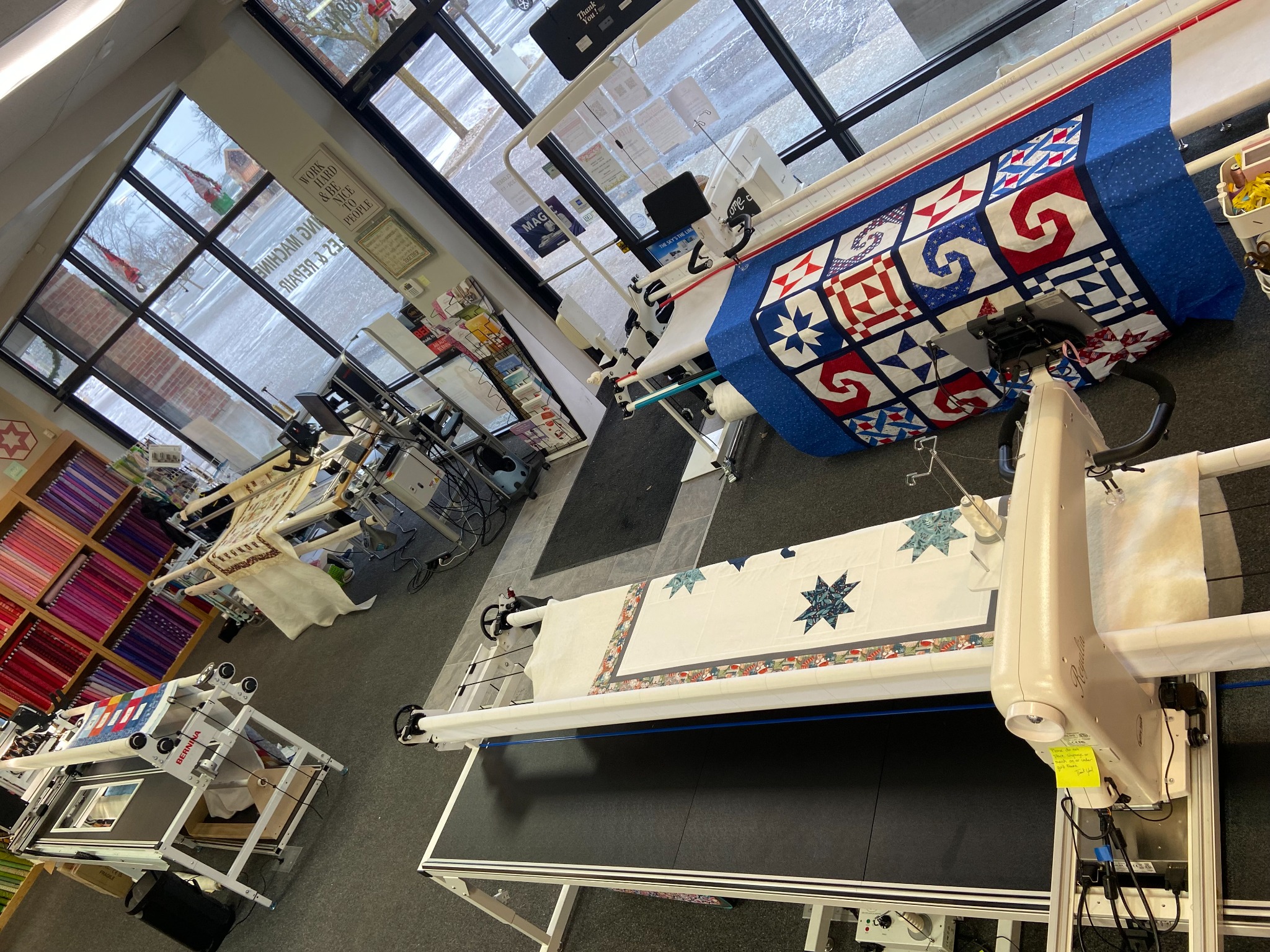 Decorative Stitch's longarm quilting studio features professional quilting machines and beautiful quilt projects in progress, providing expert custom quilting services and inspiration for every quilting enthusiast.