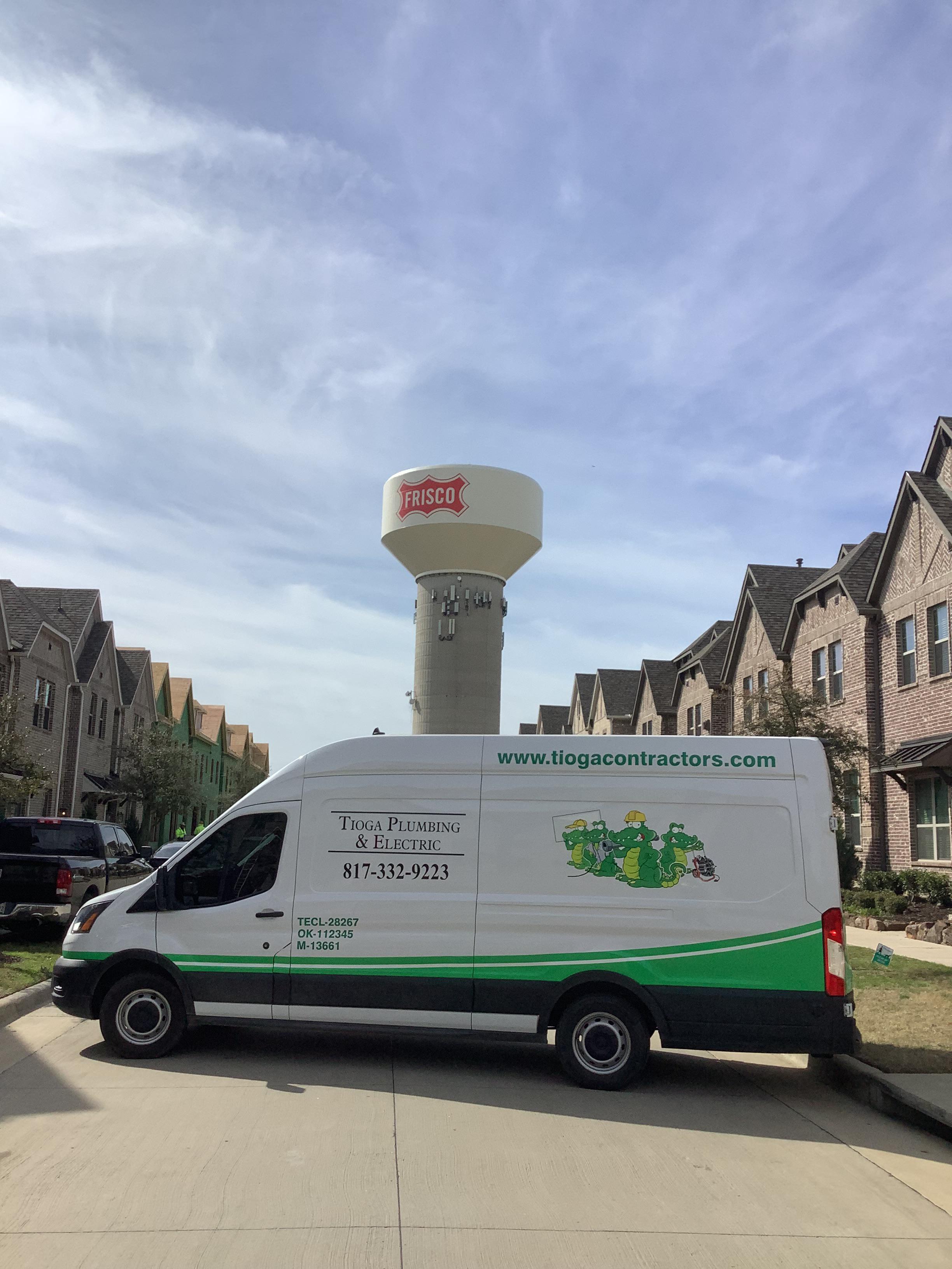 A Tioga service van in a Frisco Texas neighborhood in front of a Frisco water tower.