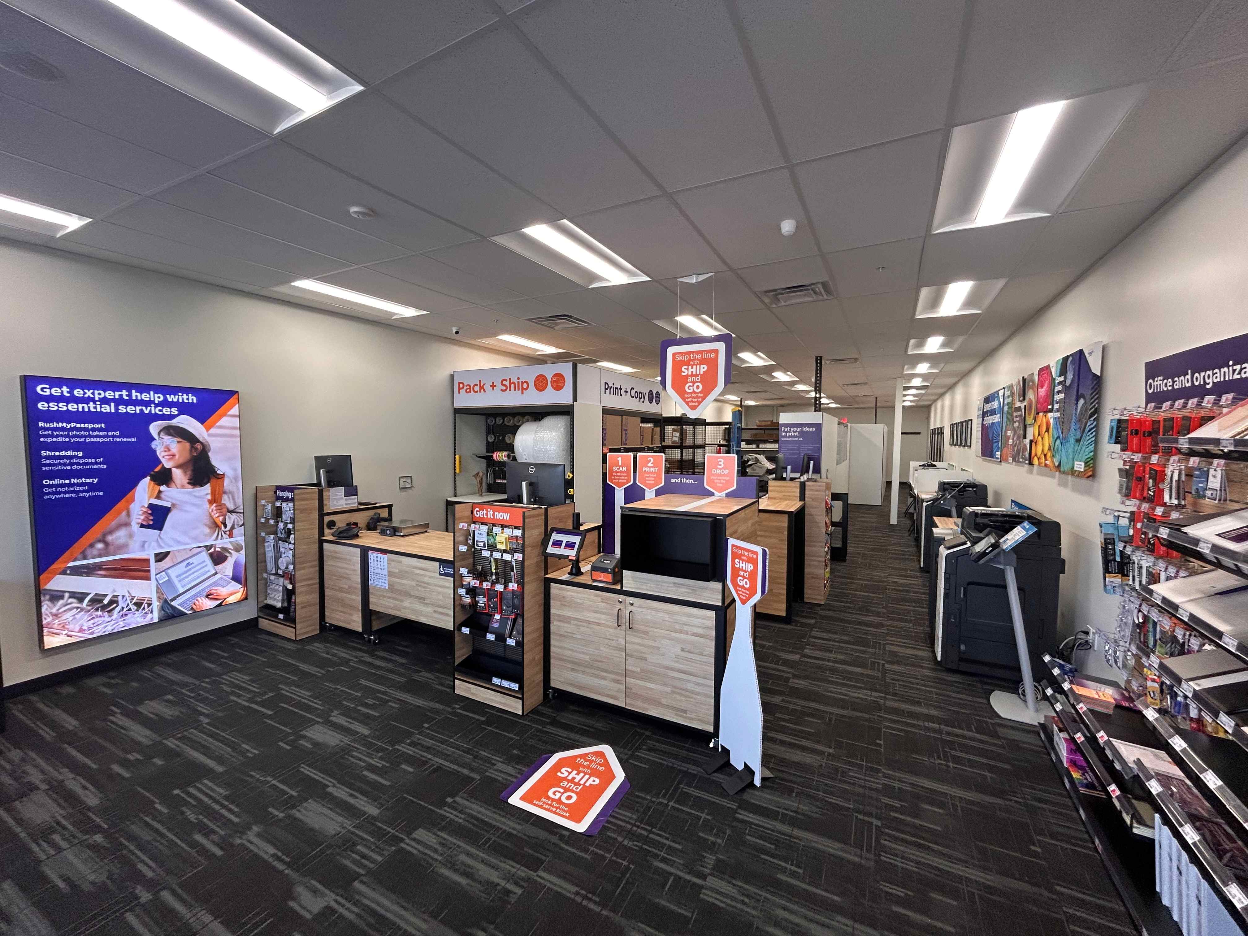 A wide overview of the clean and modern interior at the Mesa FedEx Office, showing the main service  
