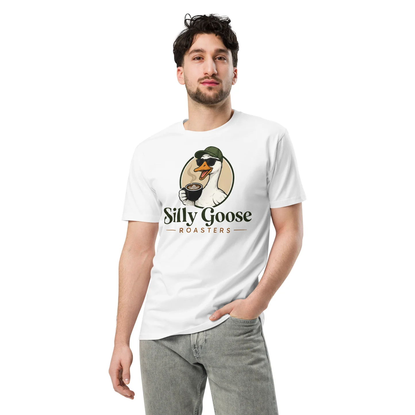 A man in a white t-shirt with a "Silly Goose Roasters" logo is shown against a white background. He has his hand in his pocket and is looking at the camera.