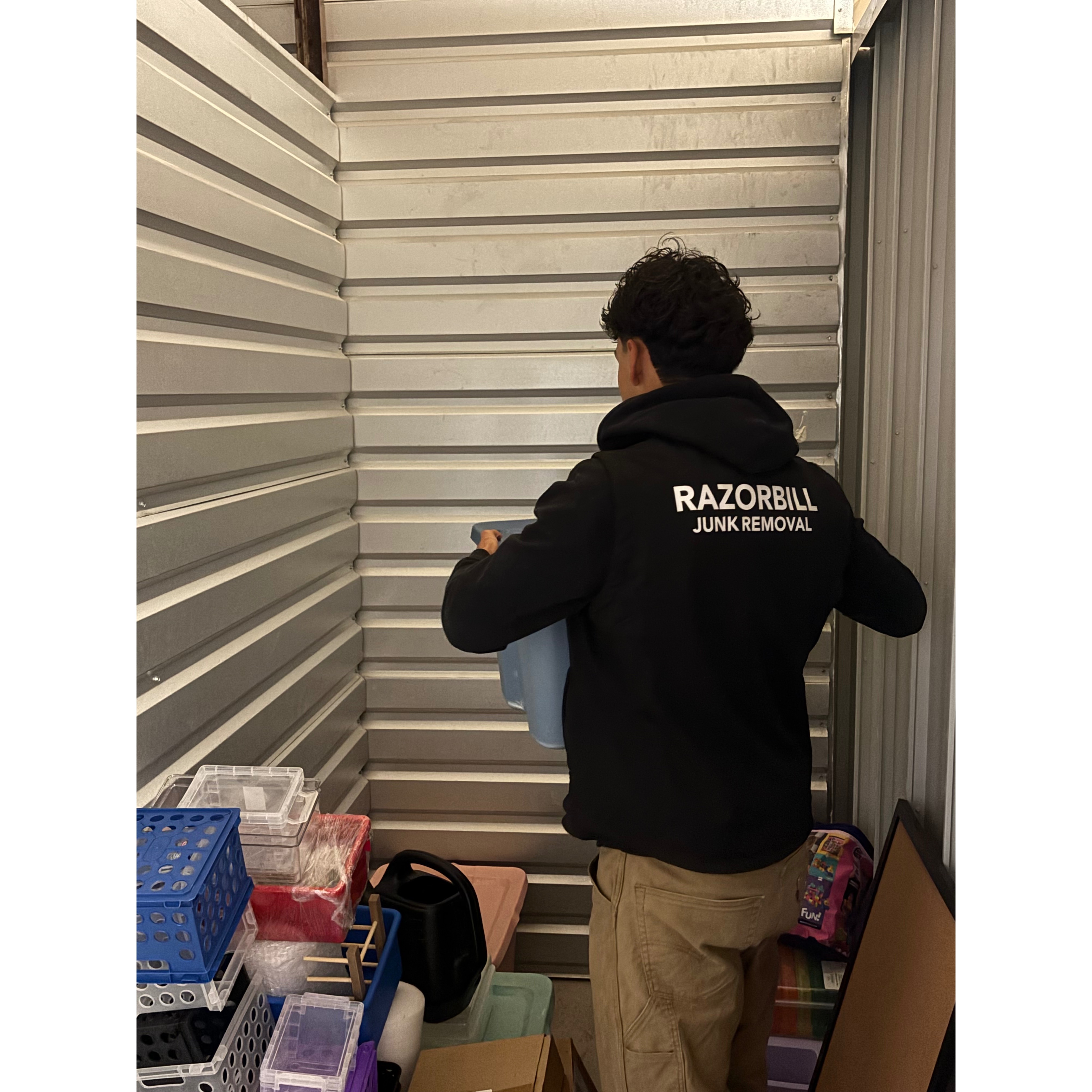 Razorbill junk removal worker cleaning out a storage unit in 78254 