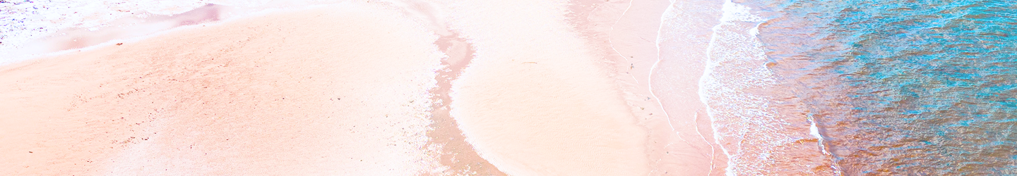 Aerial view of a sandy beach with gentle waves washing ashore.