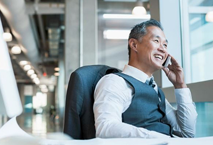 A business owner on the phone at his office.