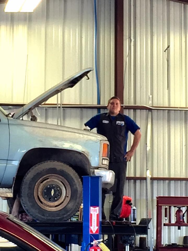 C H Auto Repair mechanic at work.