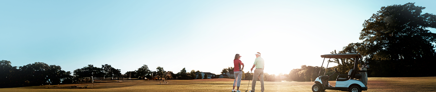 Golf partners on the green at golden hour.