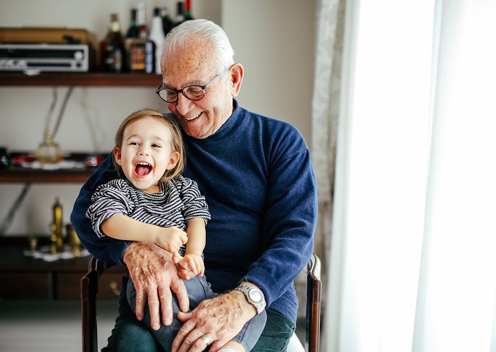 A grandfather holding his grandchild.