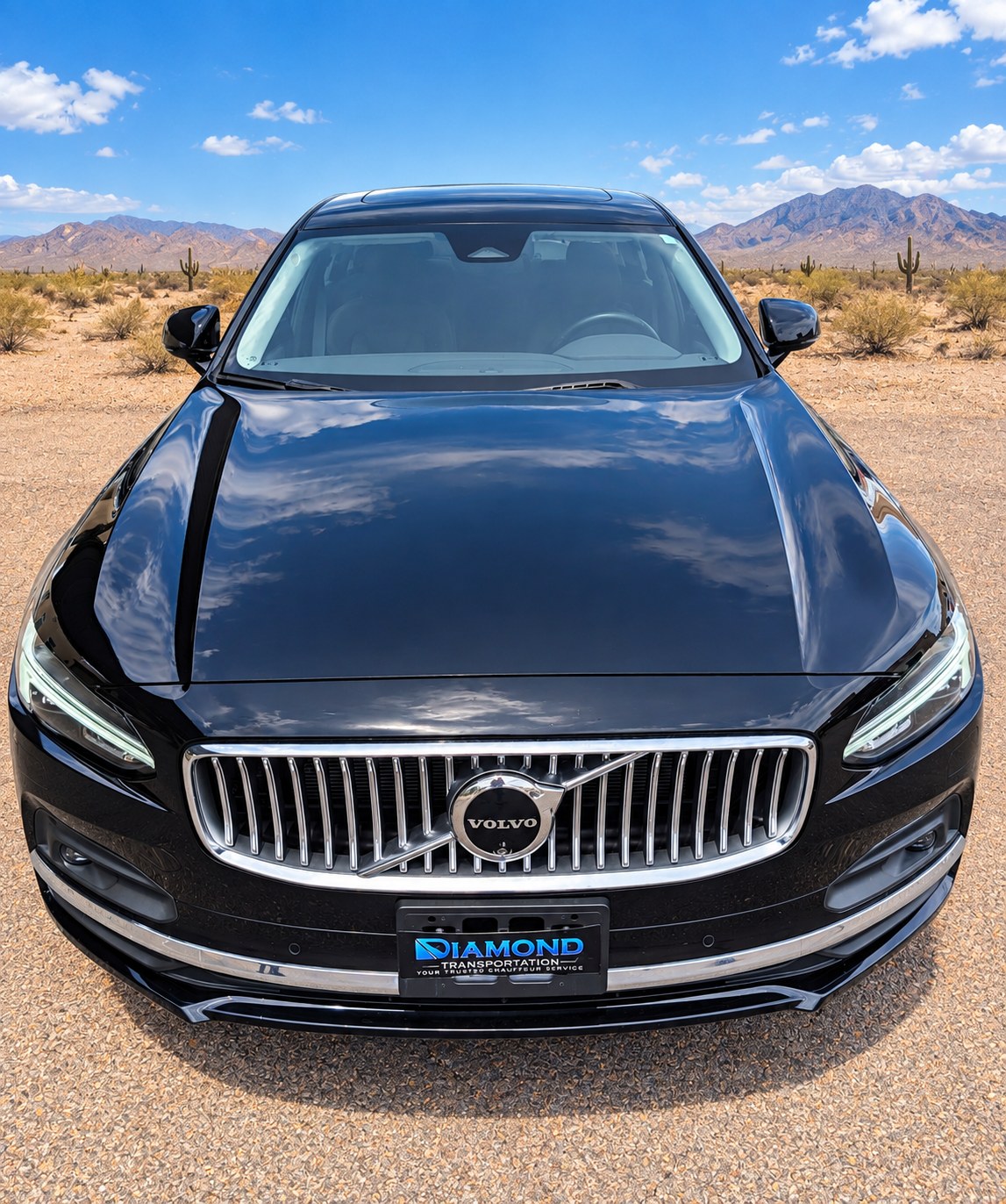 Front view of a black Volvo sedan used for private transportation.