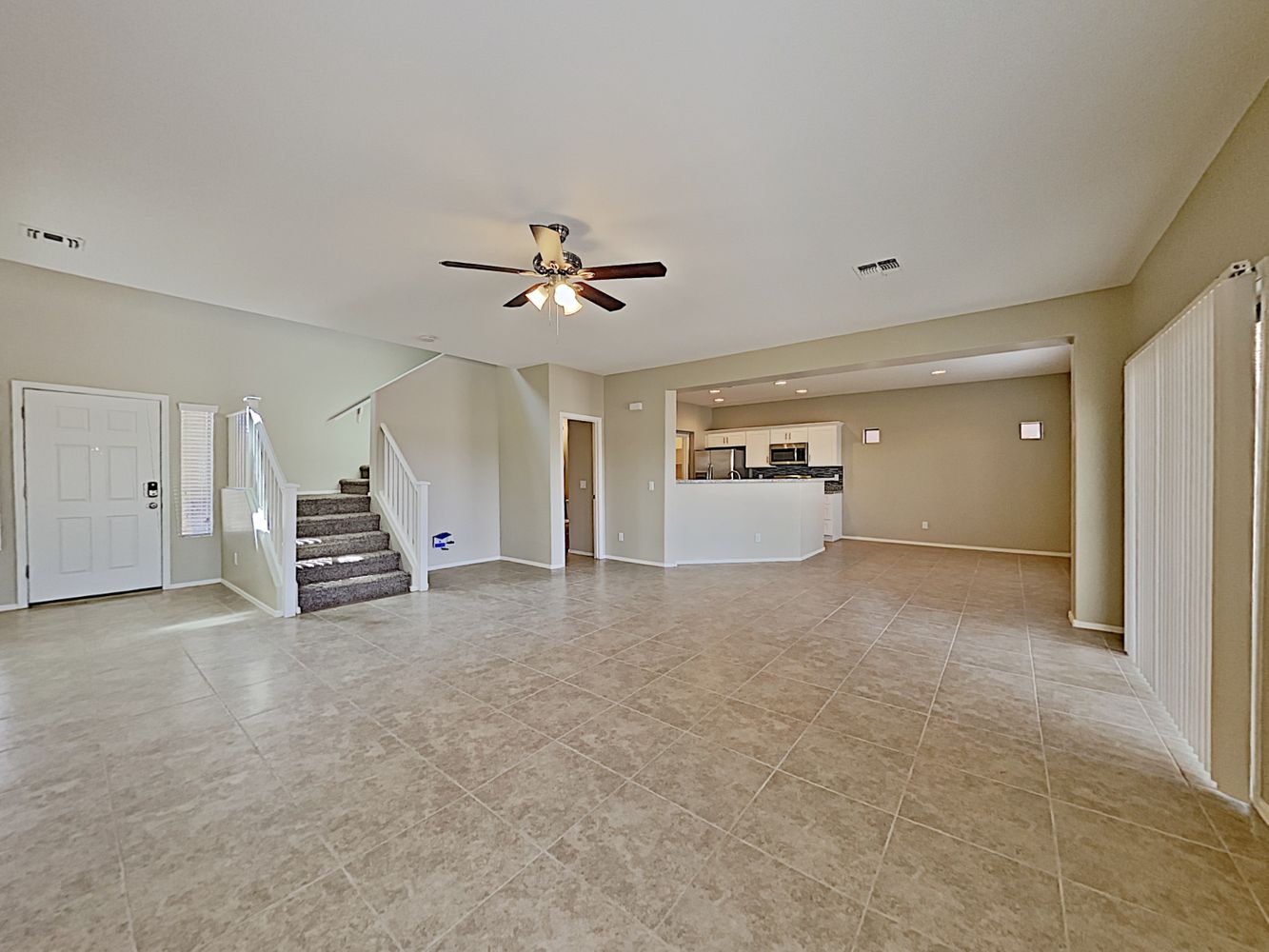 Extremely spacious living room with tile flooring at Invitation Homes Phoenix.