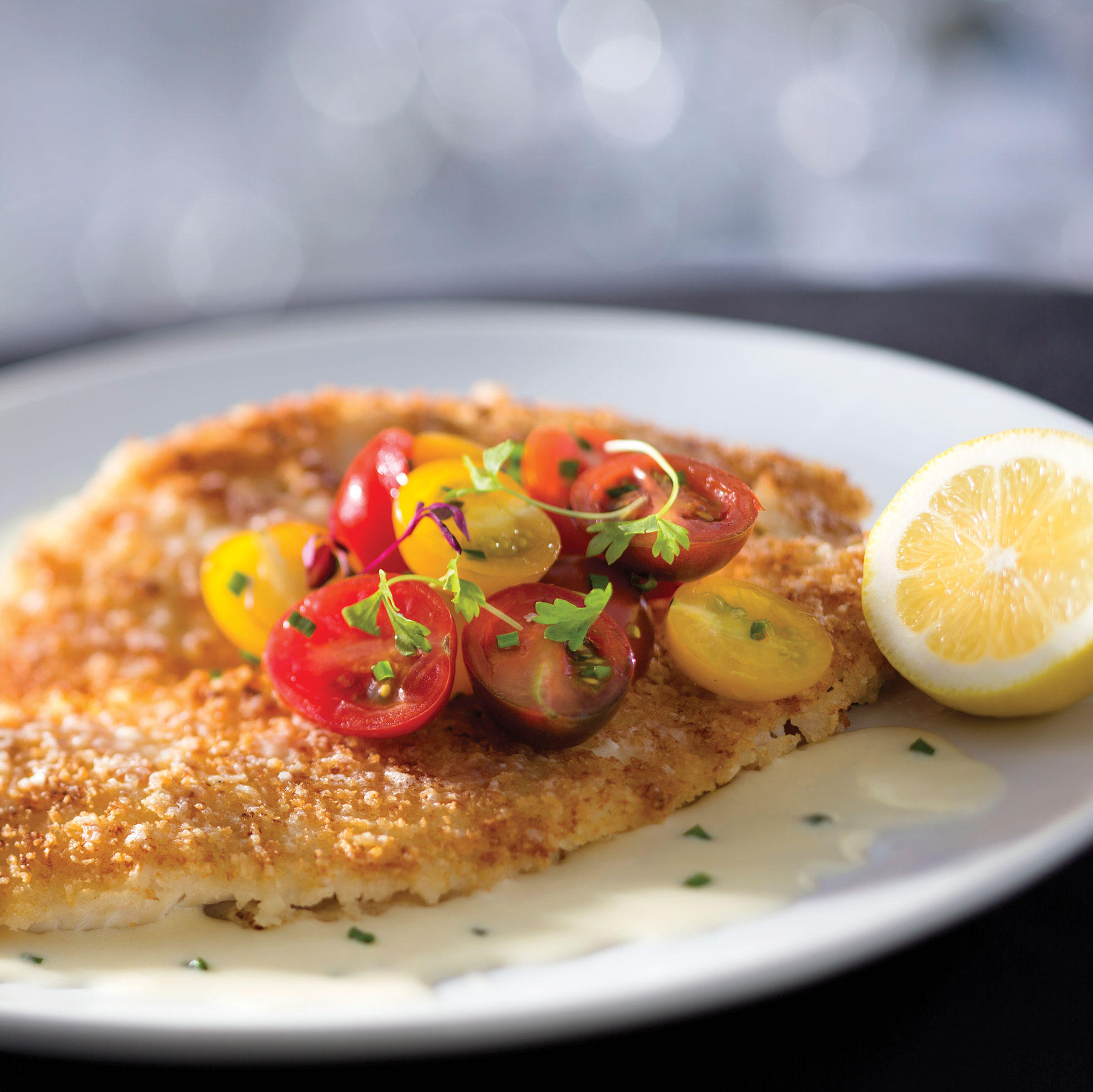Parmesan Sole served with Heirloom Tomato Salad and a Lemon-Garlic Butter Sauce.