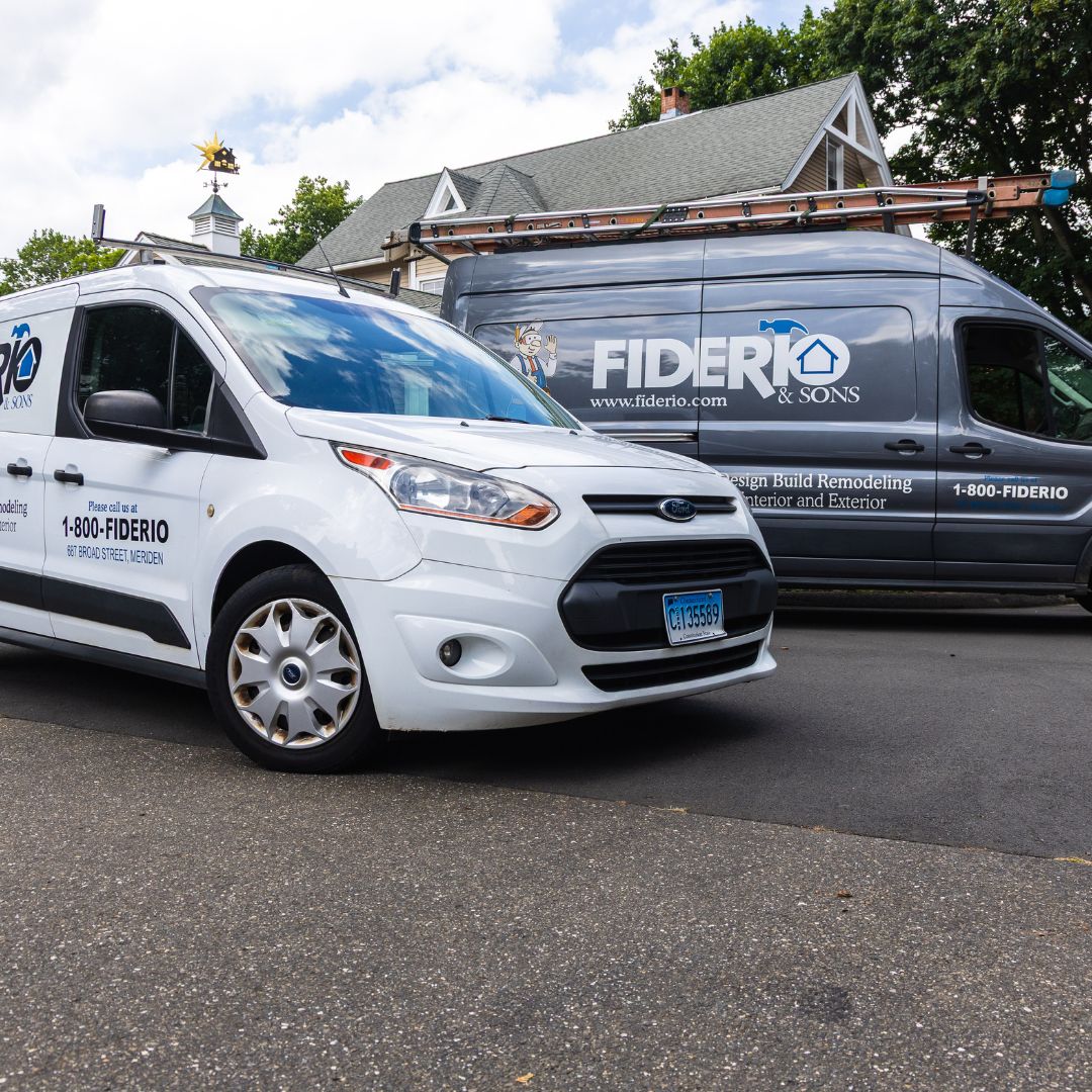 Side view of both Fiderio service vans showing off the company logo, website, and contact info.