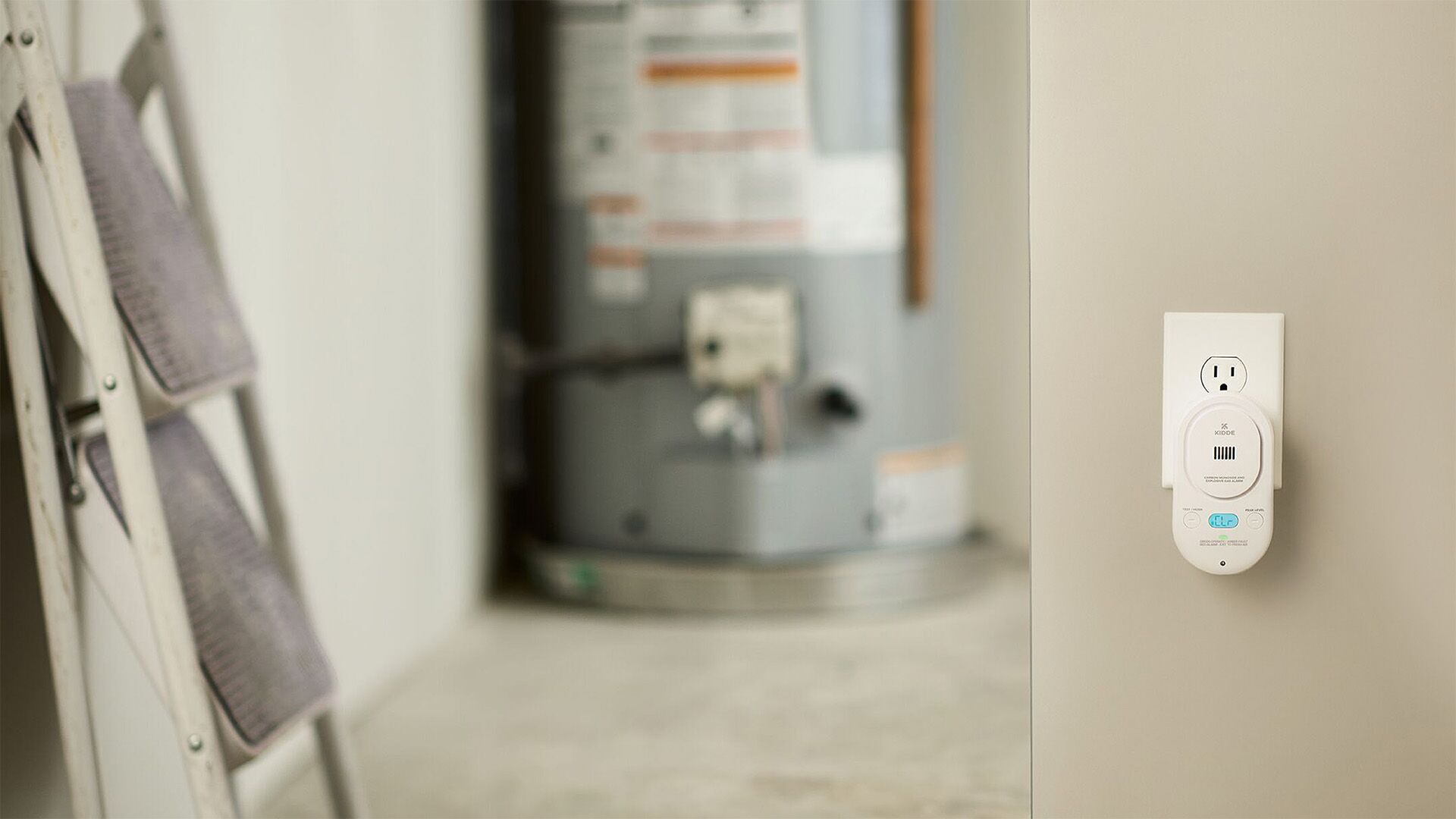 A carbon monoxide alarm is plugged into the wall.