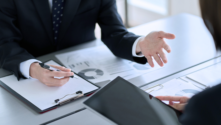 Wealth professionals reviewing portfolio data.
