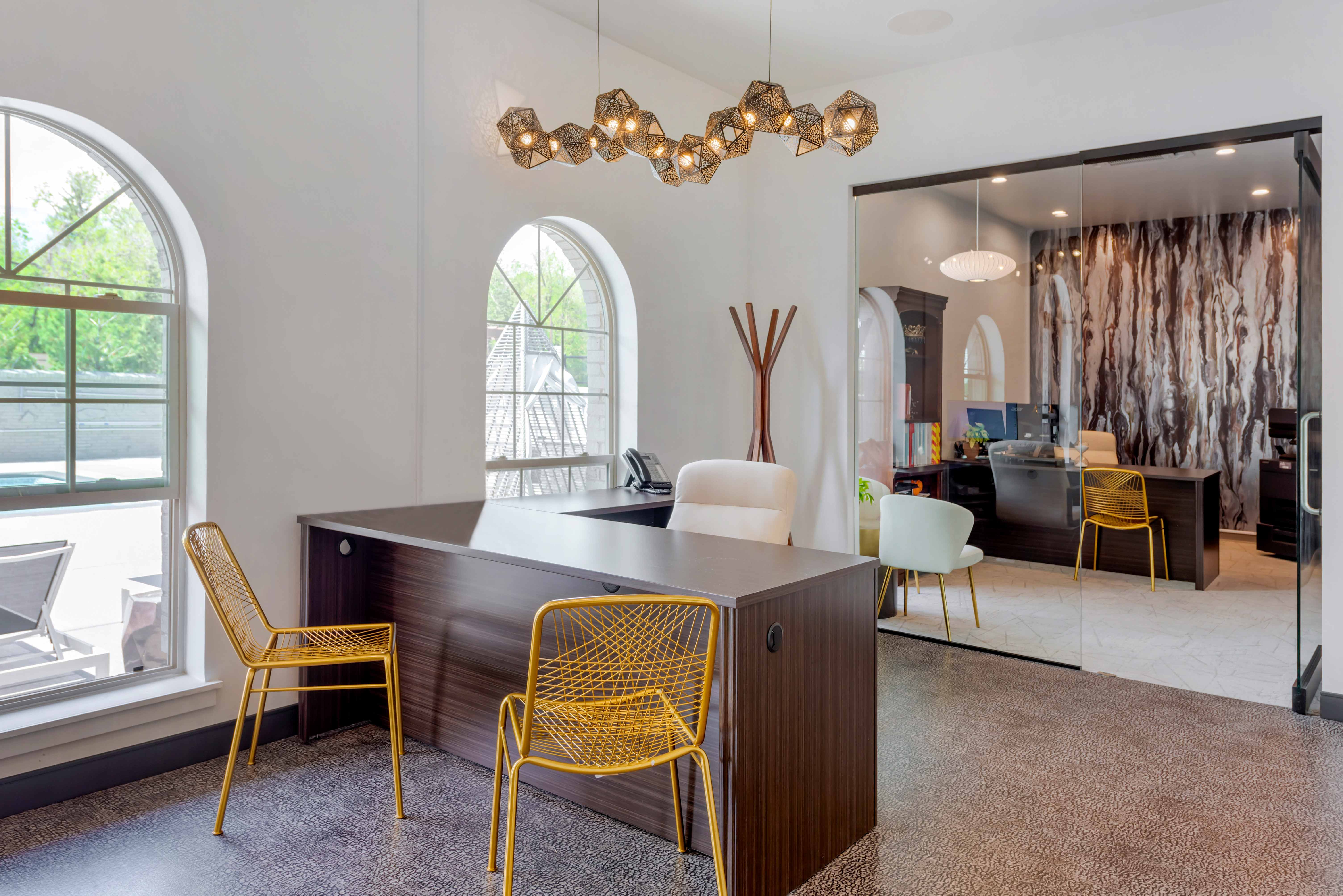 Leasing office with desks, glass wall, and modern lighting.