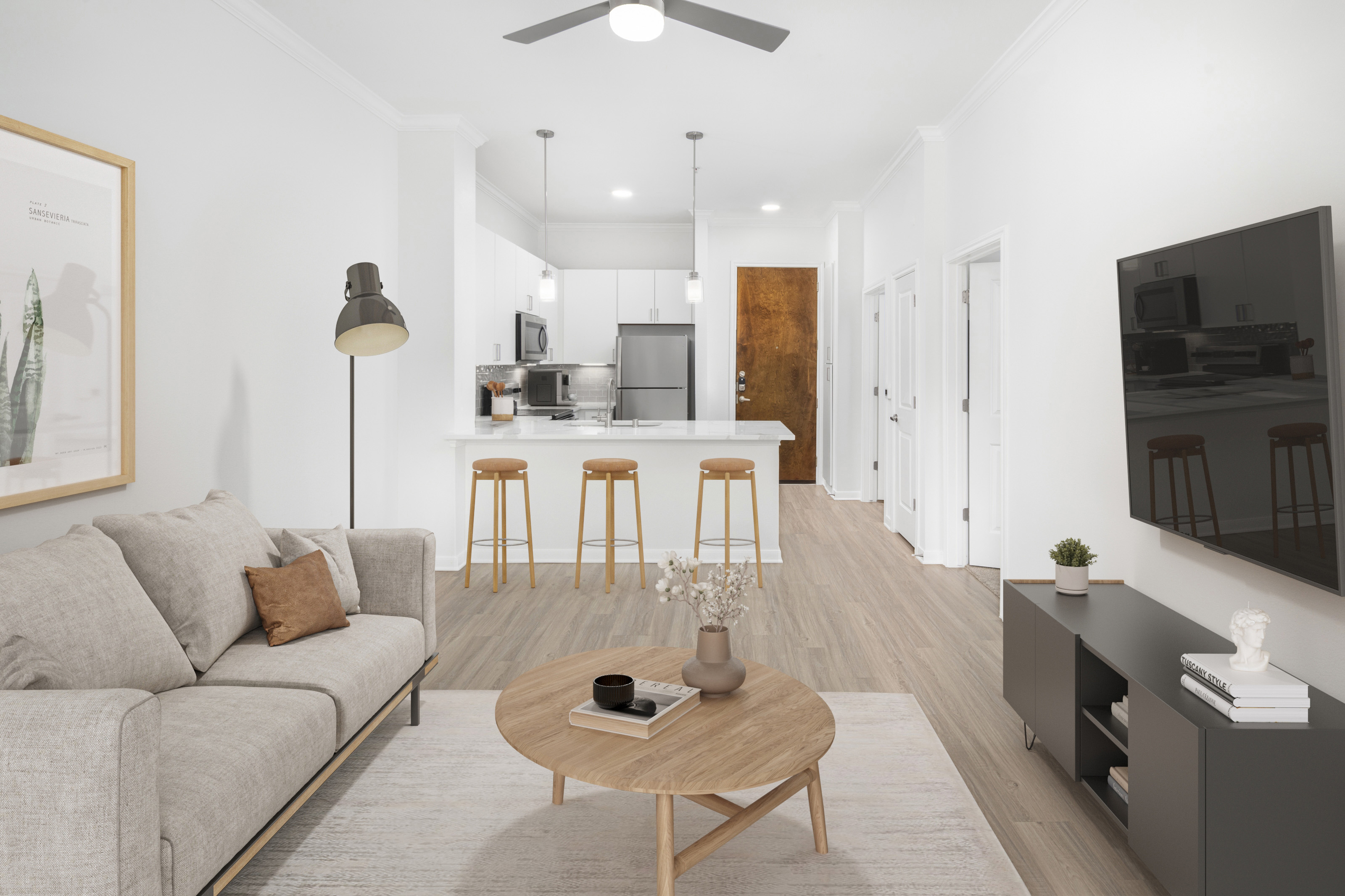 Modern finish with open concept floor plan, breakfast bar and hardwood-style flooring throughout in Camden Travis Street Apartments in Midtown Houston, Tx