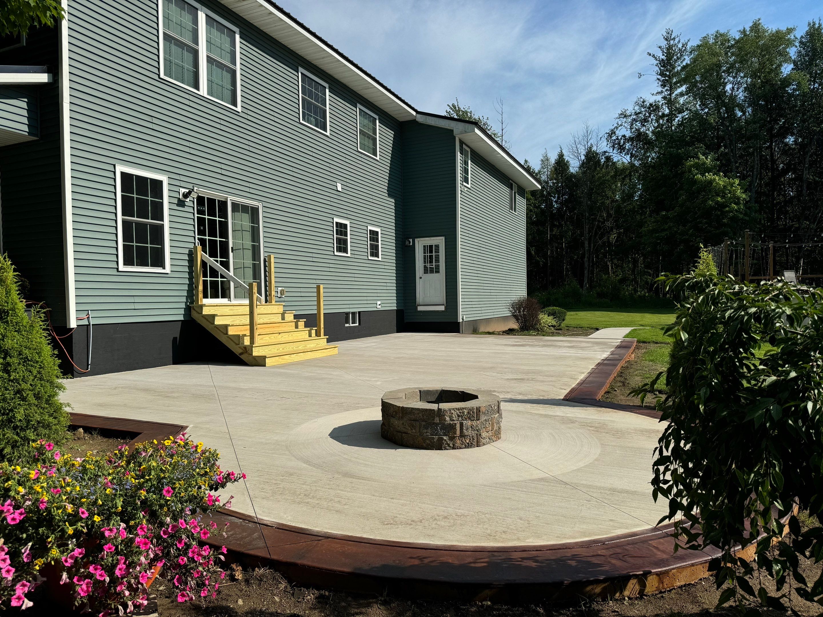 Concrete patio with a fire pit.