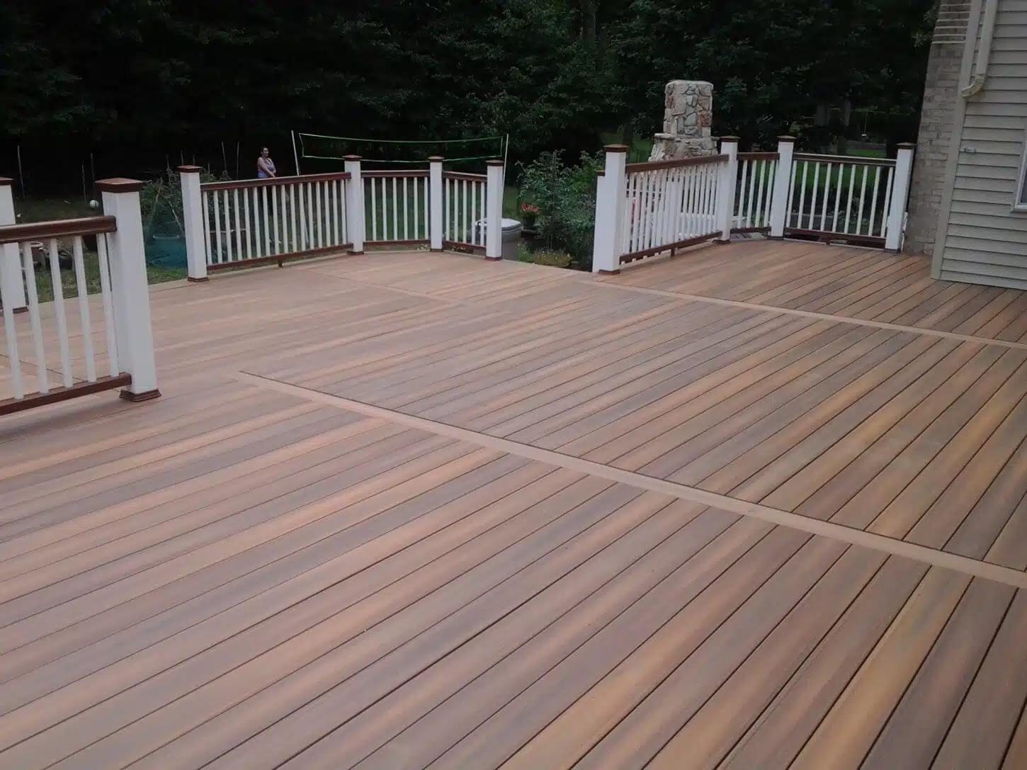 Composite Deck with white railings, built by Decks by Murray