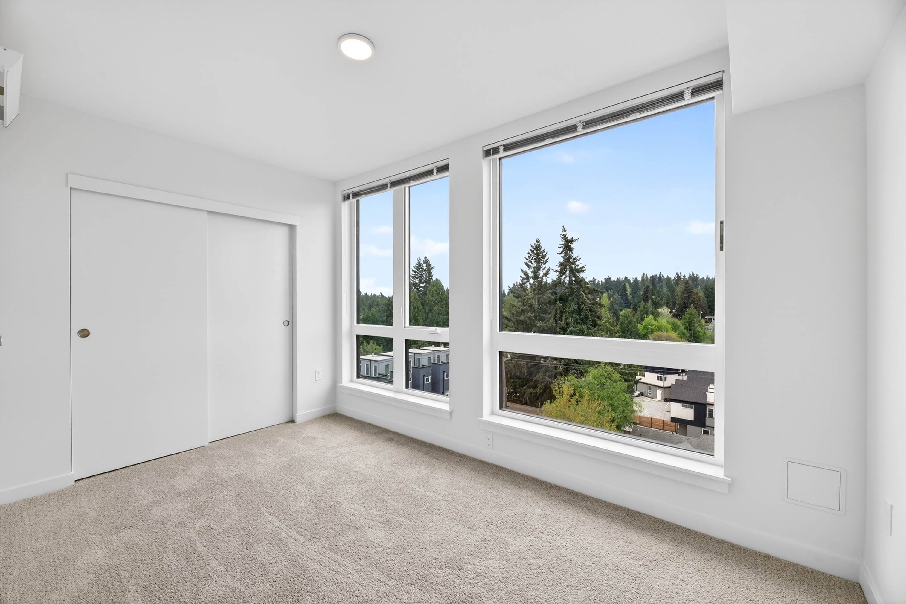 Bedroom with white walls and carpeting