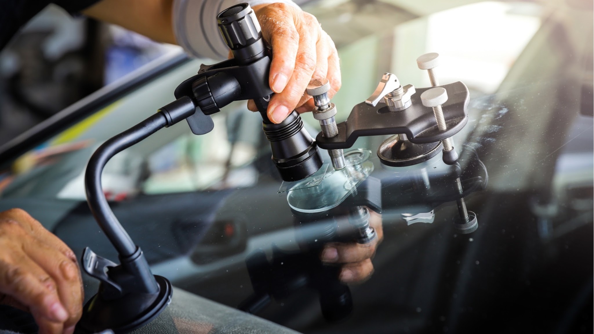 Injecting resin into a rock chip. Chips smaller than a quarter can usually be repaired in about 30 minutes at your location.
