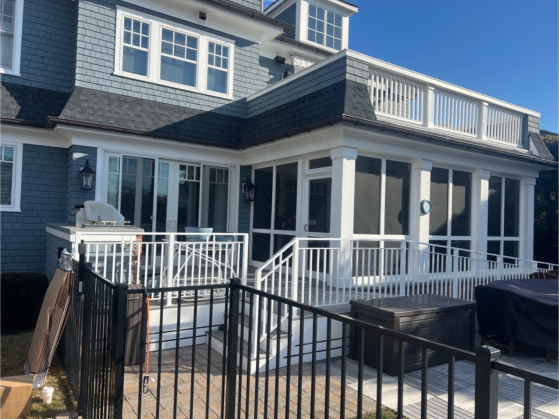 Screened outdoor living area with railings and elevated deck