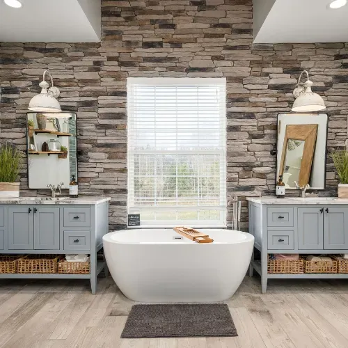 High-end bathroom remodel in Central North Carolina featuring a freestanding tub, custom cabinetry, decorative accent wall, and modern finishes. This project highlights luxury bathroom renovation and custom residential construction near Badin Lake.