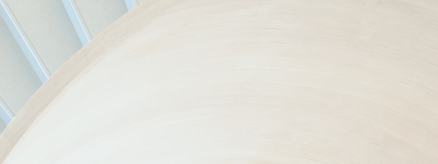 Close-up of an architecturally curved, modern wooden staircase.