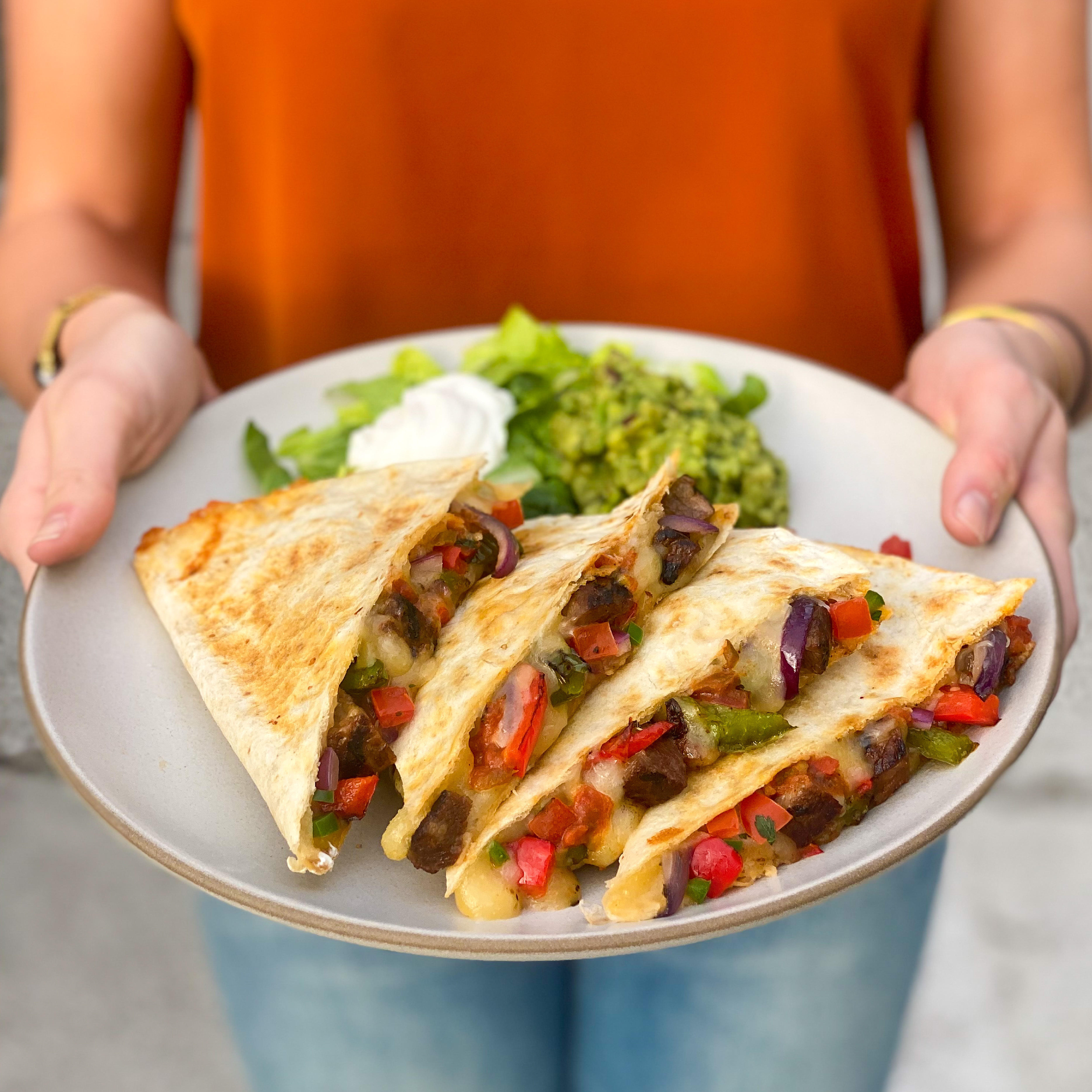 Grilled quesadillas are stuffed with chef-selected ingredients like grilled steak and hand-sliced, sauteÌed-in-house fajita vegetables.