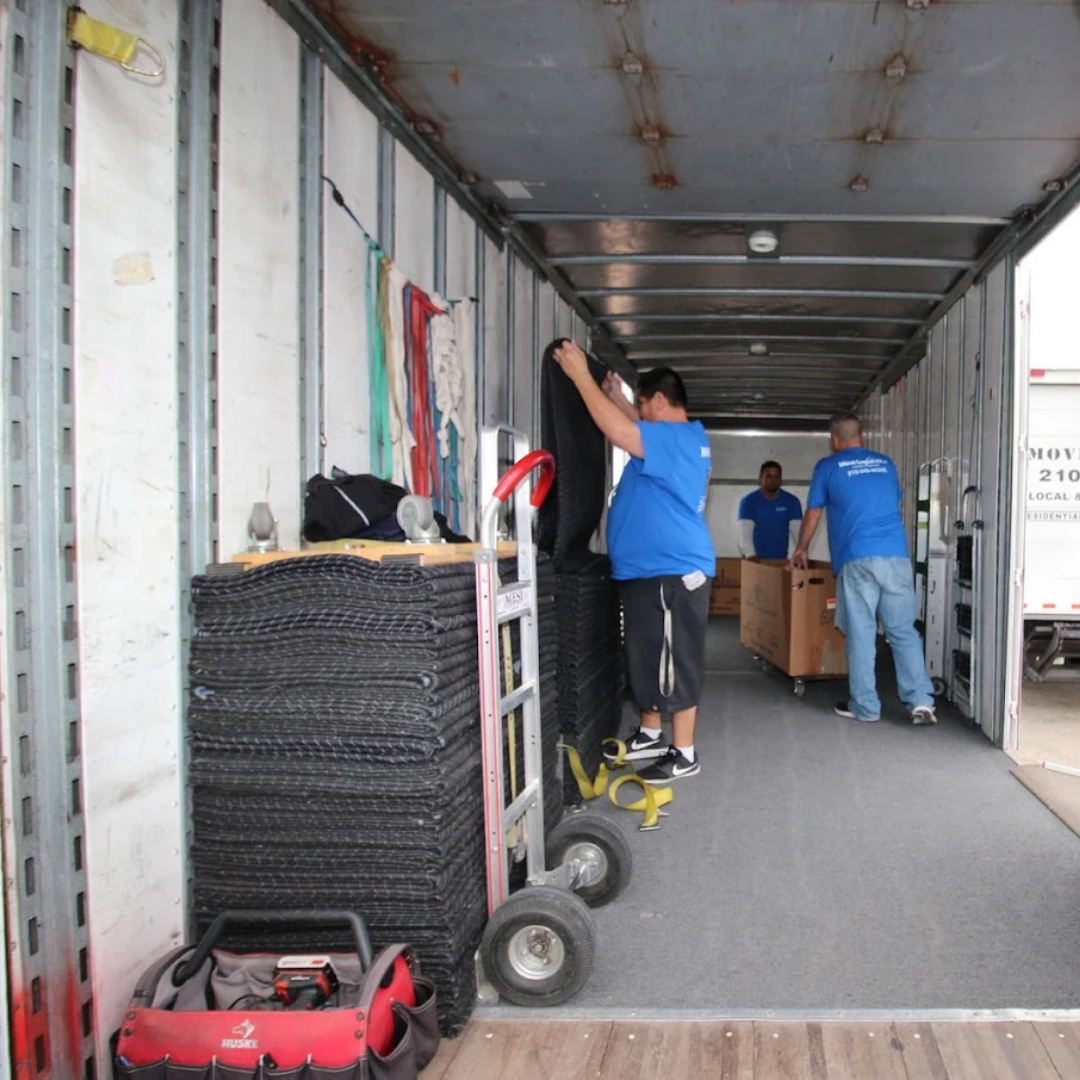 Econo Move & Storage crew preparing moving blankets and equipment inside a company truck for same-da 