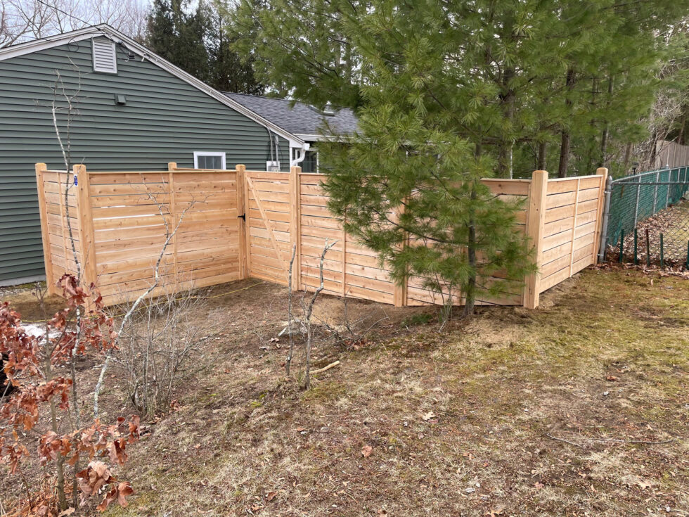 This project features 6-foot horizontal cedar fencing with a semi-privacy layout, allowing for airflow and subtle visibility while maintaining a strong sense of enclosure.