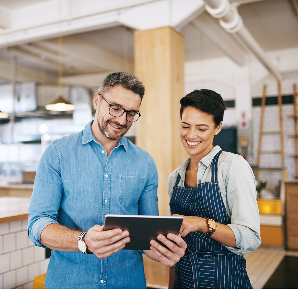 A business owner couple looking at their tablet.