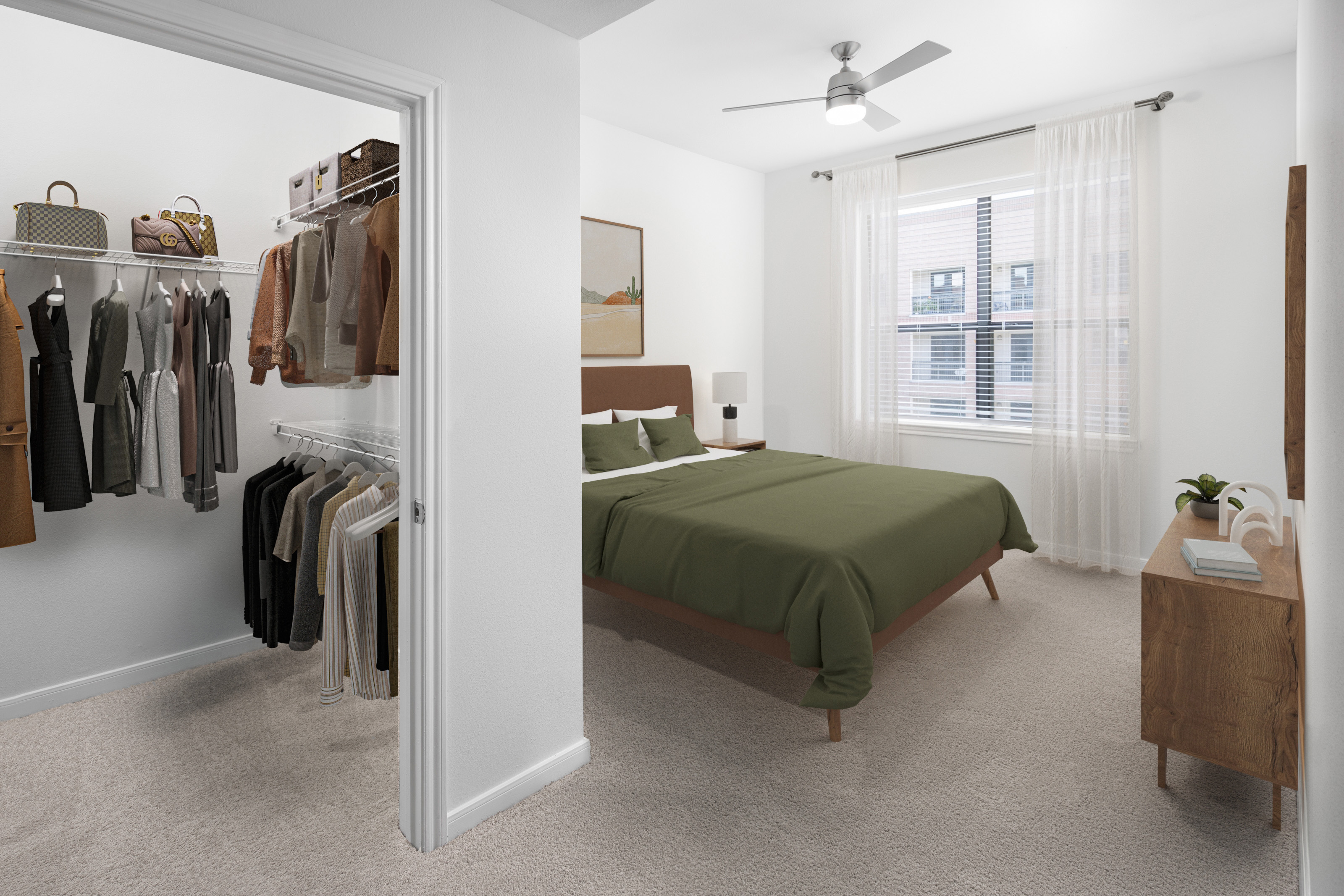 Modern bedroom with walk-in closet, modern ceiling fan, natural lighting and plush carpet at Camden Travis Street Apartments in Midtown Houston, Tx