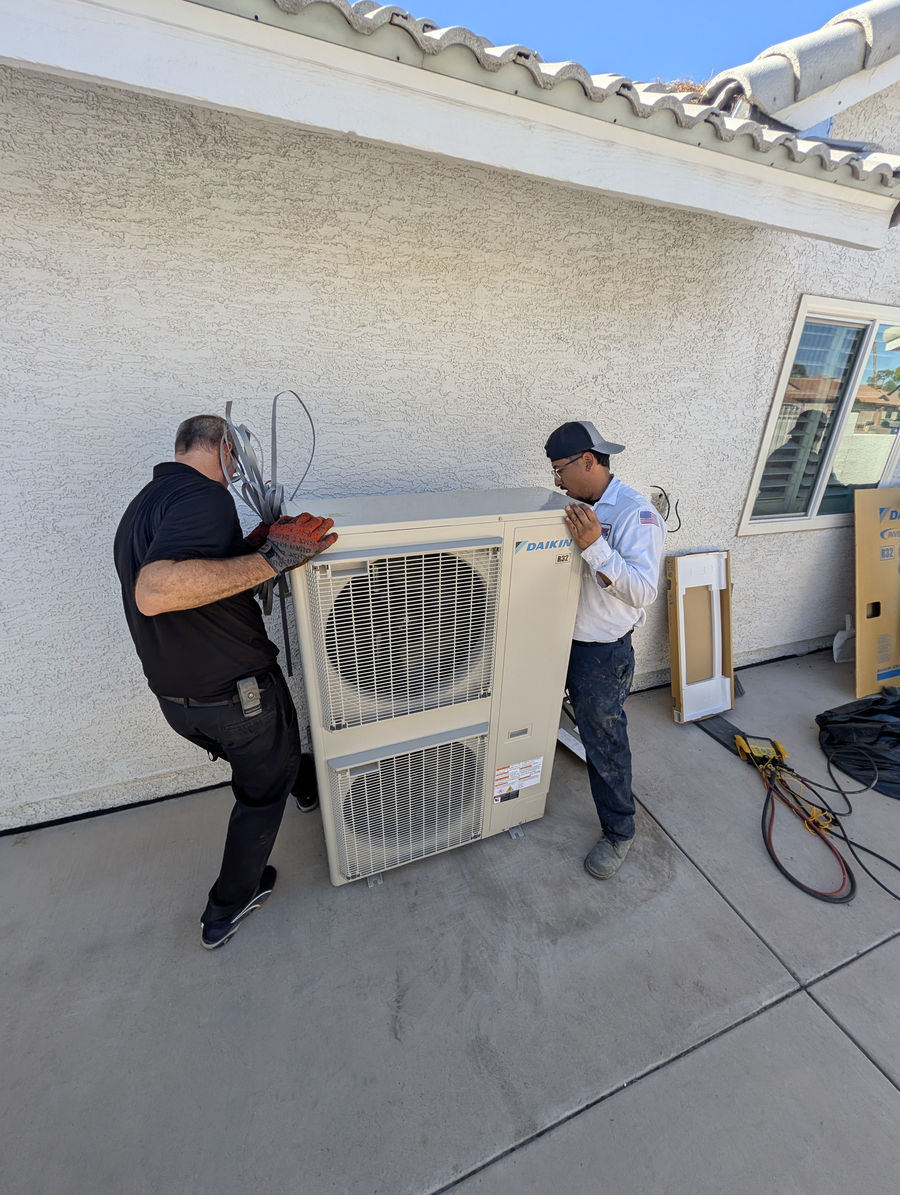 technicians installing a new 5 ton ac unit 