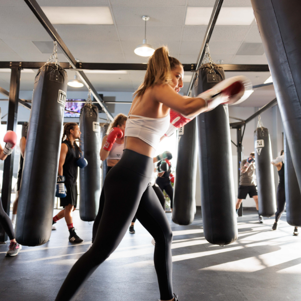 Woman hitting the bag at a TITLE Boxing Club gym TITLE Boxing Club Seattle Greenwood Seattle (206)297-5945