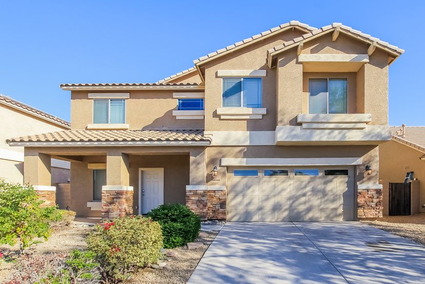 Stunning two-story home with a two-car garage and covered patio at Invitation Homes Phoenix.