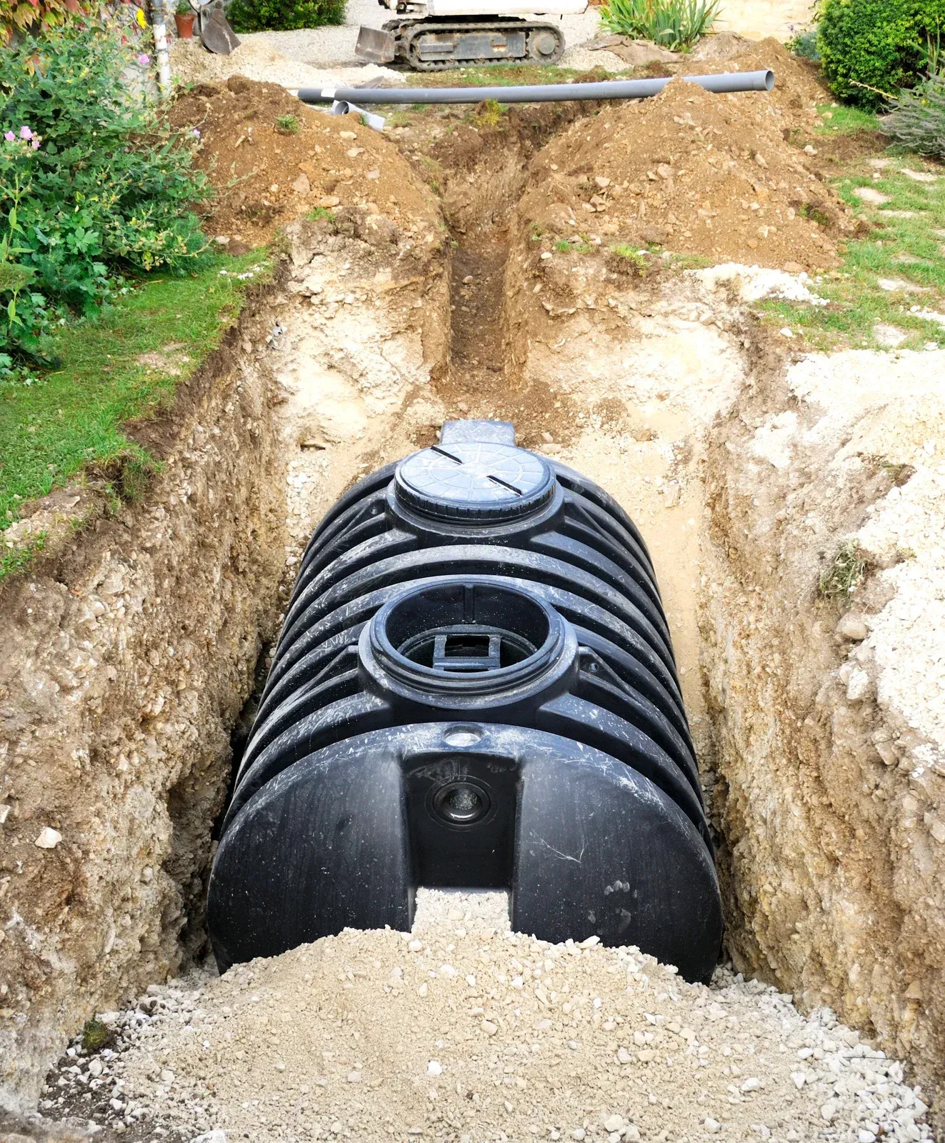 Underground drainage tank installed inside a deep excavated trench for stormwater and wastewater management. The sitework project includes excavation, trenching, utility installation, and drainage system preparation designed to improve residential property infrastructure and water flow control.