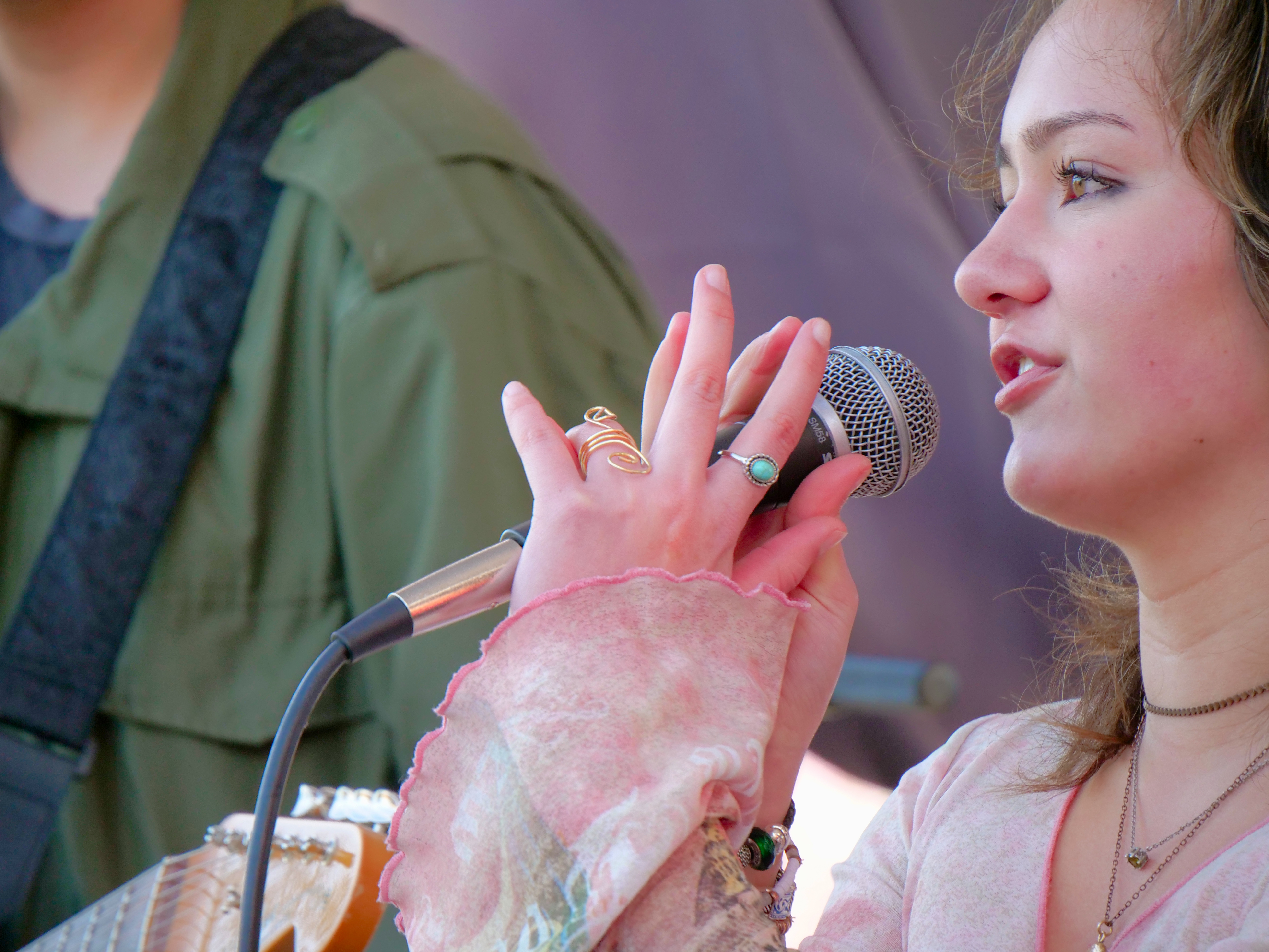 Young vocalist performing with a band, highlighting ensemble training and confidence-building music education.