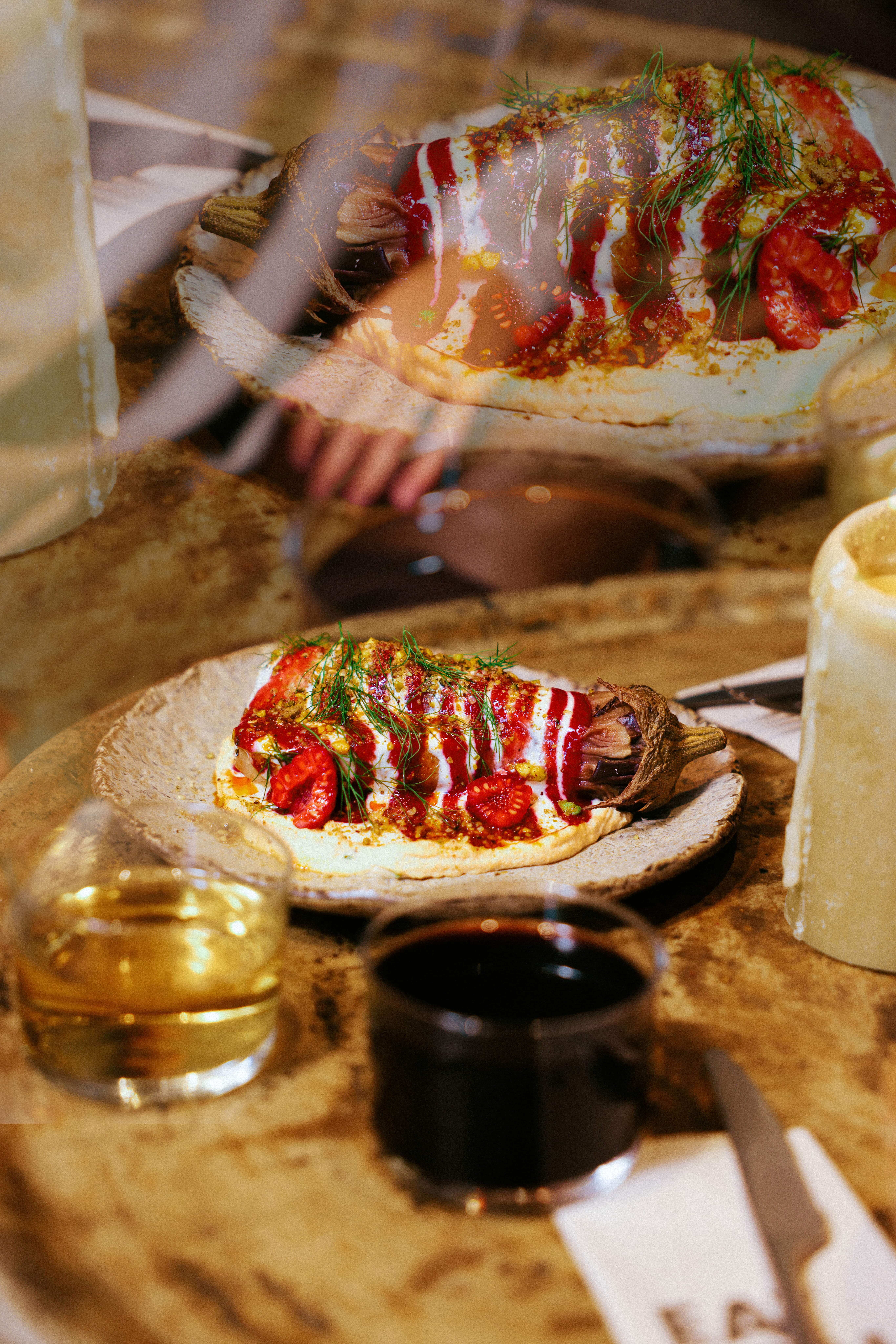 Raspberry Harissa Aubergine with raspberries, tahini dressing and herbs.