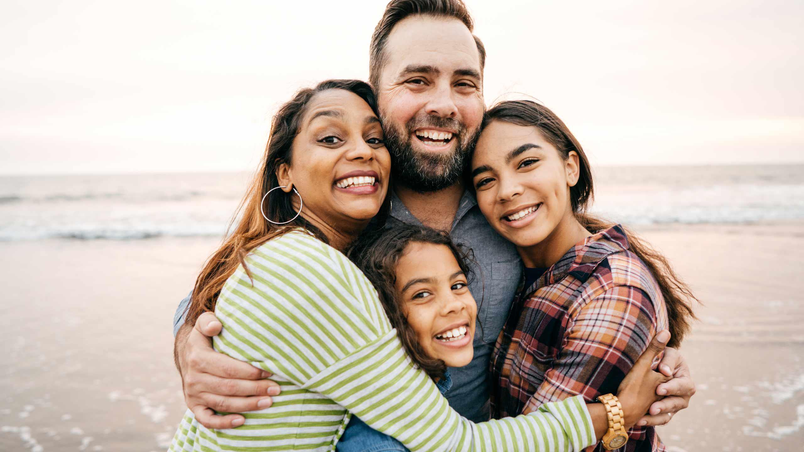 Father and mother with girls hugging and smiling