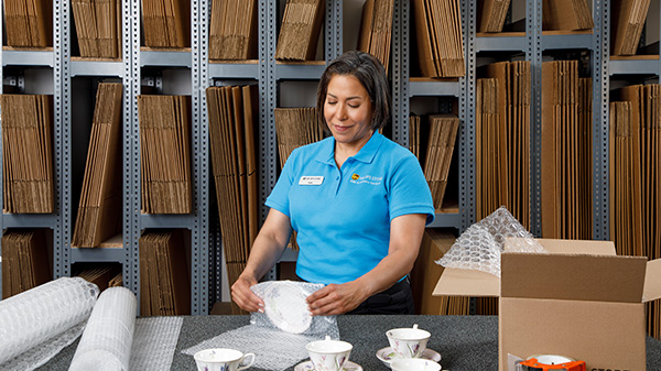 a woman prepping china for an for international shipment