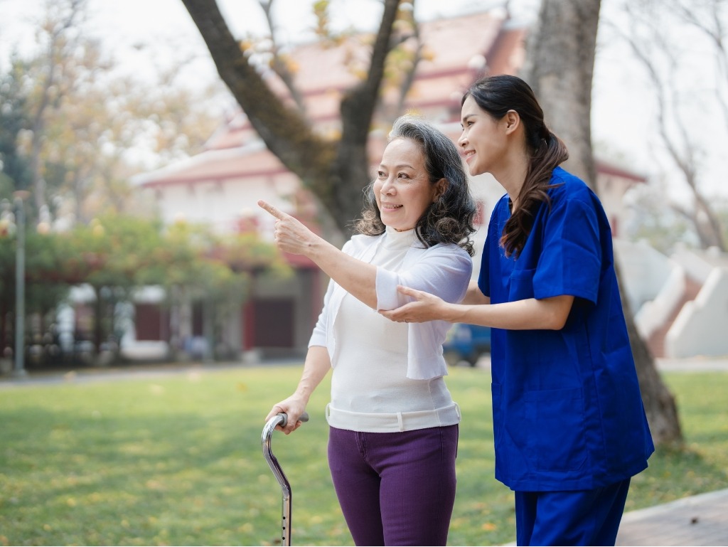 A professional caregiver from Assisting Hands Home Care supports a senior client during a safe, enjoyable walk outdoors. Our Lexington, MA caregivers provide mobility assistance, companionship, and encouragement so seniors can stay active and confident in their community.