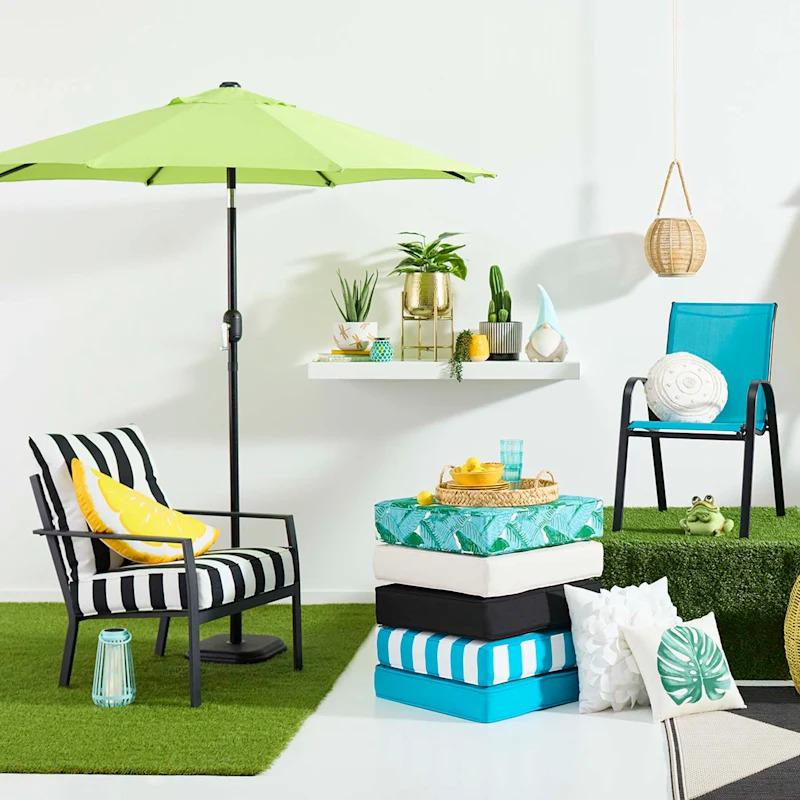 Colorful outdoor patio cushions arranged neatly on a wicker chair, creating a cozy and inviting outdoor seating area.