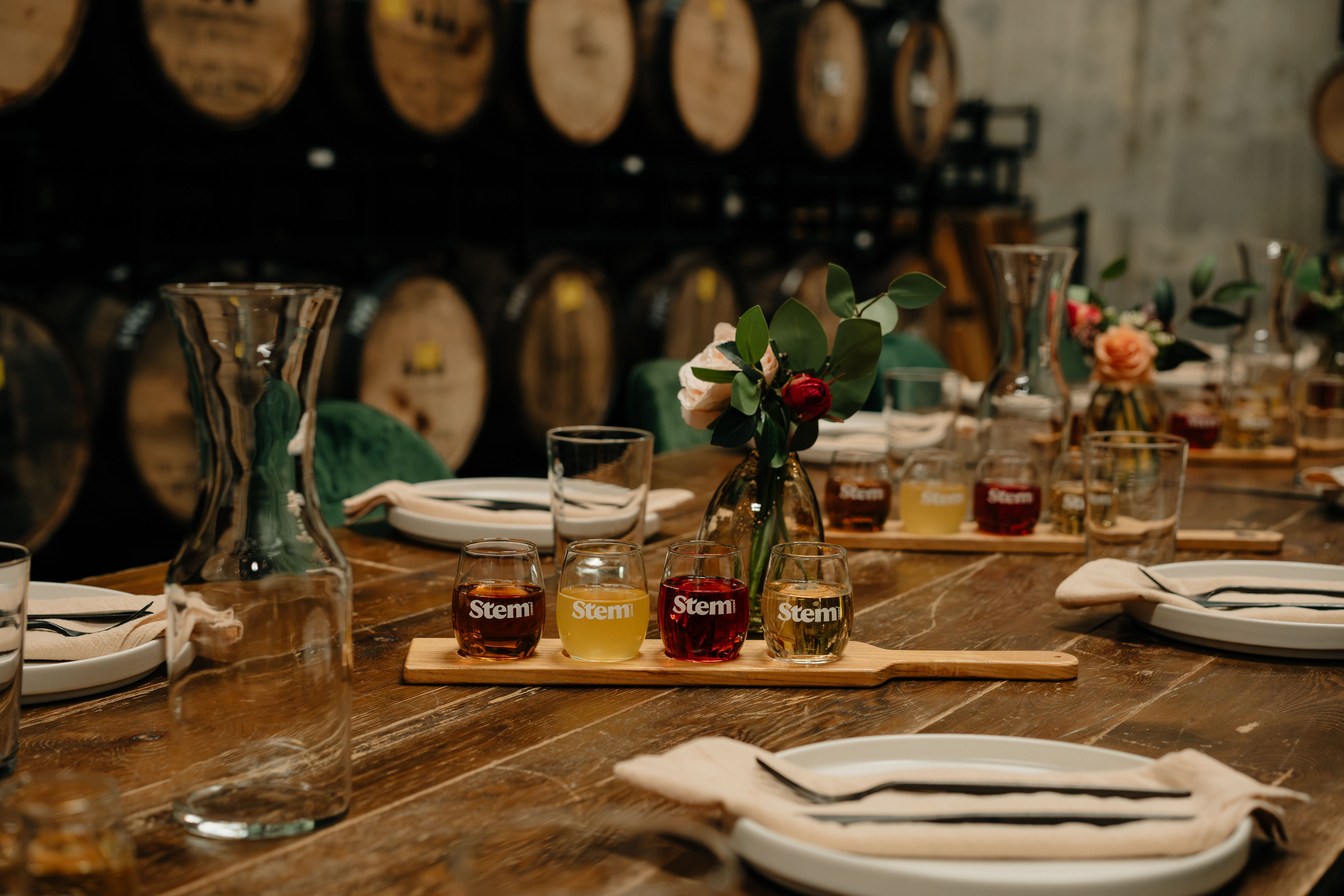 An elegant private dining experience surrounded by cider barrels showcases Acreage's event and celebration spaces.