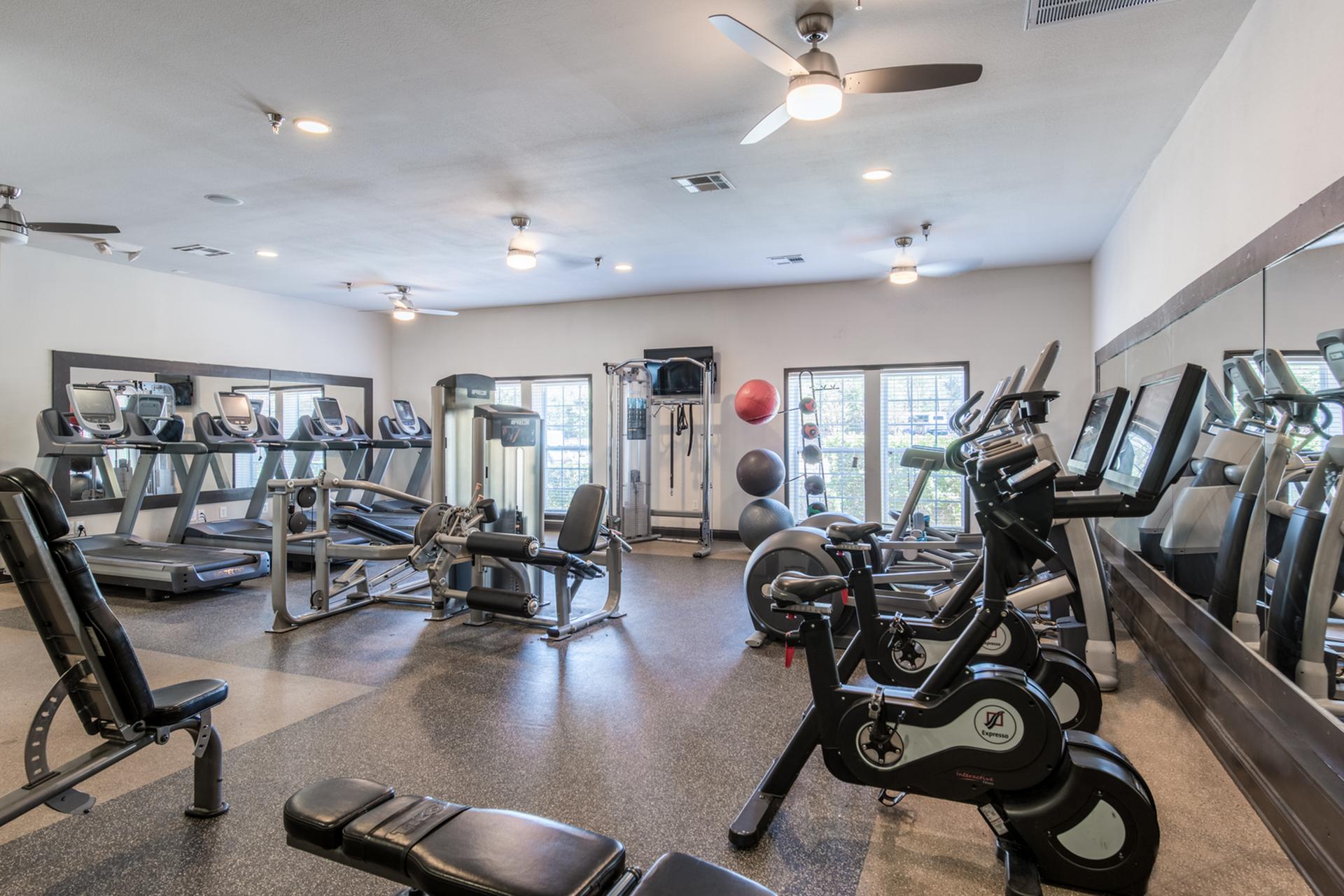 On-site gym with treadmills, weights, stationary bicycles, and other workout equipment. Central House on Stadium Apartments Mobile (251)272-4710