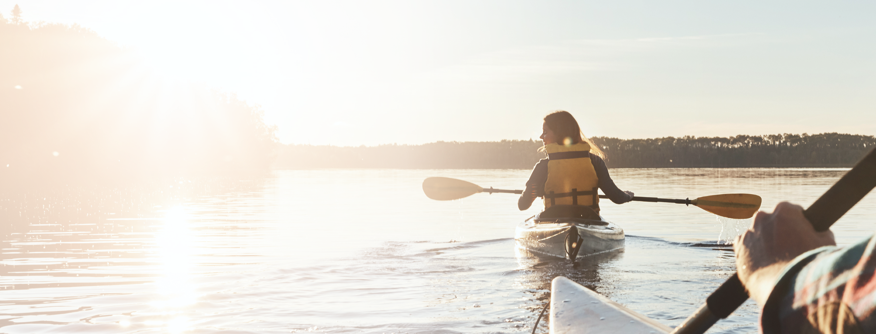 Two people kayaking on a sunny day.