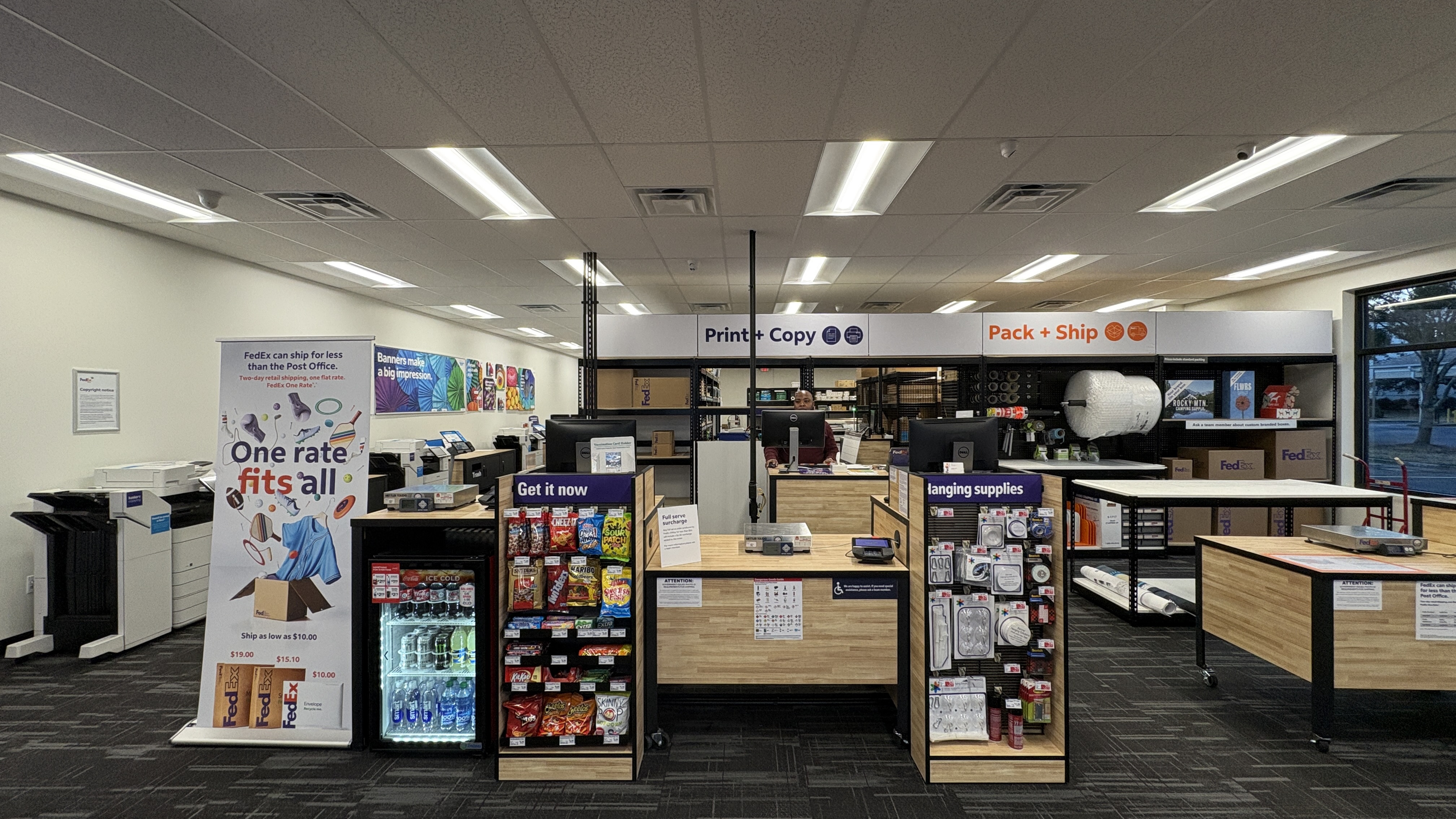 Convenient Shipping & Snack Center: A look at our main counter, offering FedEx One Rate shipping, packing services, and a selection of snacks and drinks for your convenience while you wait.