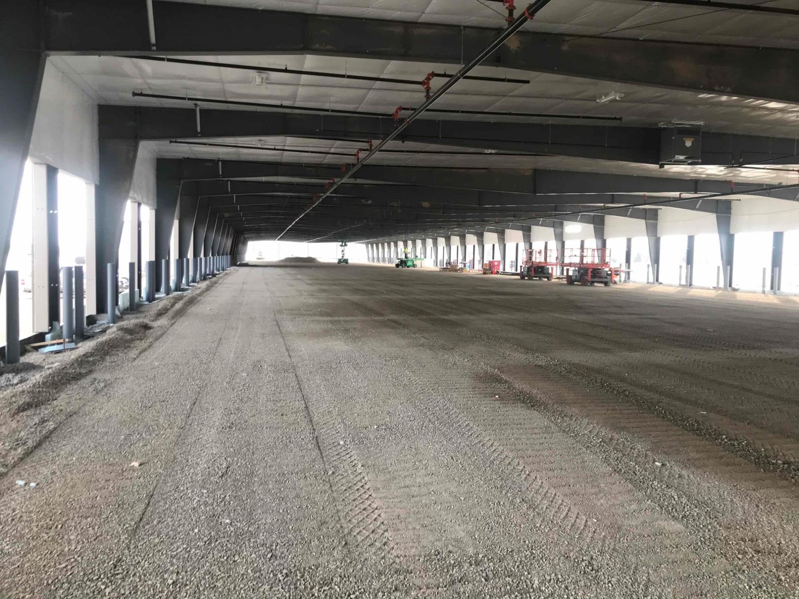 Distribution terminal interior construction with concrete slab prep steel columns and dock leveler installation by commercial general contractor