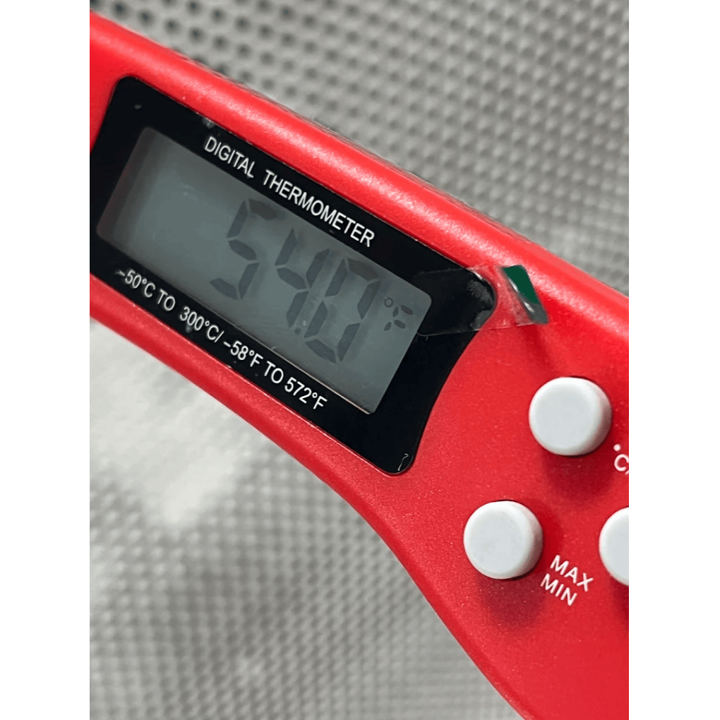 HVAC technician using digital thermometer to measure air conditioning temperature for system diagnostics by Gotcha Heating and Air Inc in Spring Hill Florida