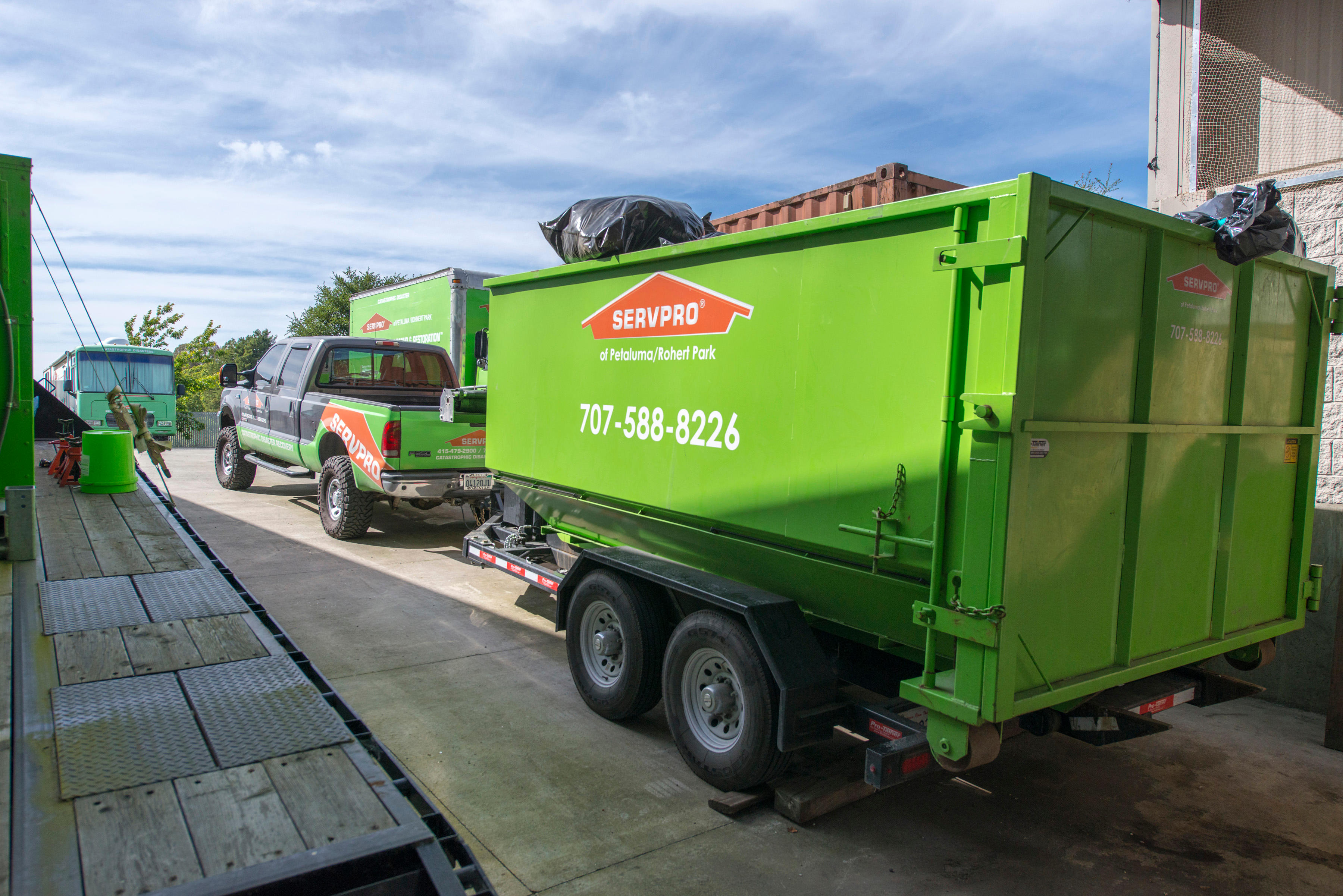 SERVPRO of Petaluma/Rohnert Park/Santa Rosa truck and trailer used for water, fire, and smoke damage restoration services.