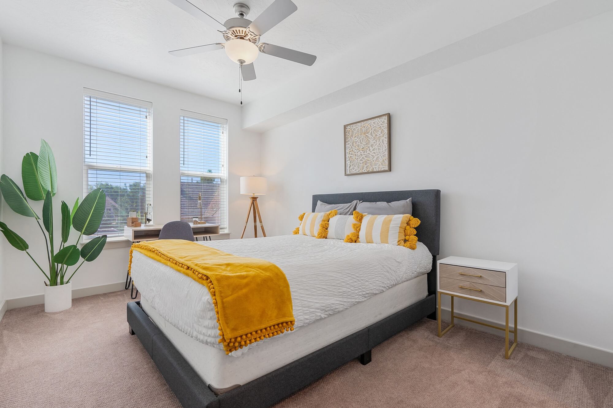 a bedroom with a bed and a ceiling fan
