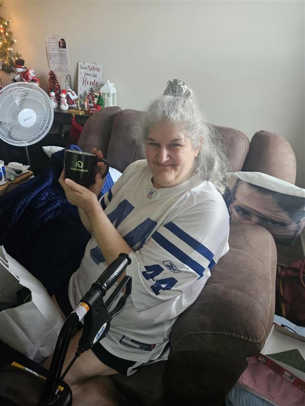 Older adult remaining comfortable at home with support from in-home care services.