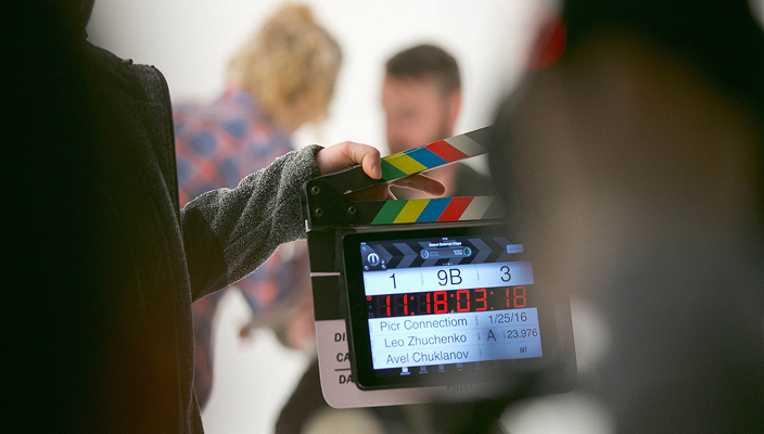Someone holding a clapperboard.